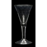 A large mid 18th century wine glass: with trumpet-shaped bowl, on air tear stem and folded foot, 26.