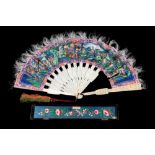 A late 19th century Cantonese fan: the paper leaf decorated with figures in a pagoda landscape each