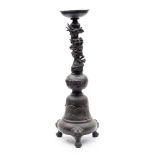 A Japanese bronze tripod stand: of baluster form, the neck applied with a sinuous scaly dragon,
