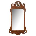 A Georgian mahogany and partly gilt fret cut mirror:, with pierced Ho-ho bird cresting,