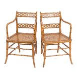 A pair of painted beech and simulated bamboo elbow chairs in the Regency taste:,