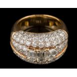 A diamond mounted domed cluster ring: the three principal, baguette-cut diamonds approximately 0.