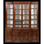 A Regency mahogany breakfront library bookcase:, the upper part with a moulded cornice,