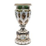 A Bohemian green overlay glass vase: of footed form,