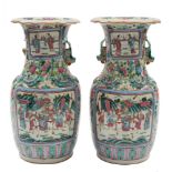 A pair of Canton famille rose baluster vases: the shoulders applied with lion dogs and chilong,