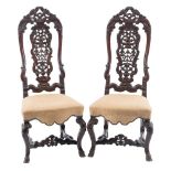 A pair of early 18th Century Indo Portuguese carved hardwood dining chairs:,