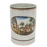 A 'Prattware' pearlware cylindrical mug: painted with an oval panel of cottages and ruins in a