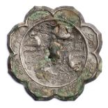 A Chinese silvered bronze mirror: of foliate eight lobed form, cast with birds, flowers and foliage,