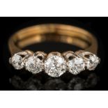 A graduated diamond five-stone ring: with round old brilliant-cut diamonds estimated to weigh a