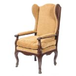 An 18th Century French Provincial oak wing armchair:, with upholstered back,