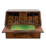 An early 18th Century walnut veneered and cross and feather banded bureau:,