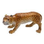 A Meissen porcelain figure of a leopard: naturalistically modelled and painted,