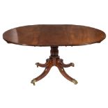 A mahogany circular extending dining table in the Regency taste:,