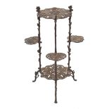 A wrought iron tiered occasional table:, of pierced leaf design,