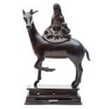 A 19th century Chinese bronze figure of Lu-Hsing: seated on the back of a stag,