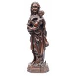 A late 19th century German carved wood Madonna and Child: raised on a stepped rectangular base with