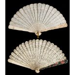 A 19th century Cantonese ivory brise fan: carved to both sides with figures in a pagoda landscape,