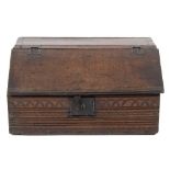 A late 17th Century oak bible box:, having a sloping hinged top with reeded bands and dentil edges,