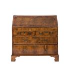 An early 18th Century walnut and cross and feather banded bureau:,