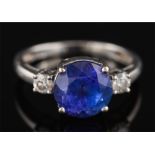 A modern tanzanite and diamond ring: the round tanzanite approximately 8.7mm diameter x 6.