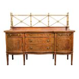 An Edwardian mahogany and inlaid sideboard:, of serpentine fronted outline,