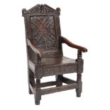 A 17th Century carved oak open armchair:,