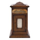 A late Victorian/Edwardian oak domestic letter box: with stepped domed top,