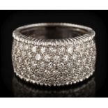 An 18ct white gold and diamond band cluster ring: with a 10mm wide band,