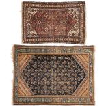 A Hamadan rug:, the indigo field with a geometric lozenge boteh design and pastel blue border,