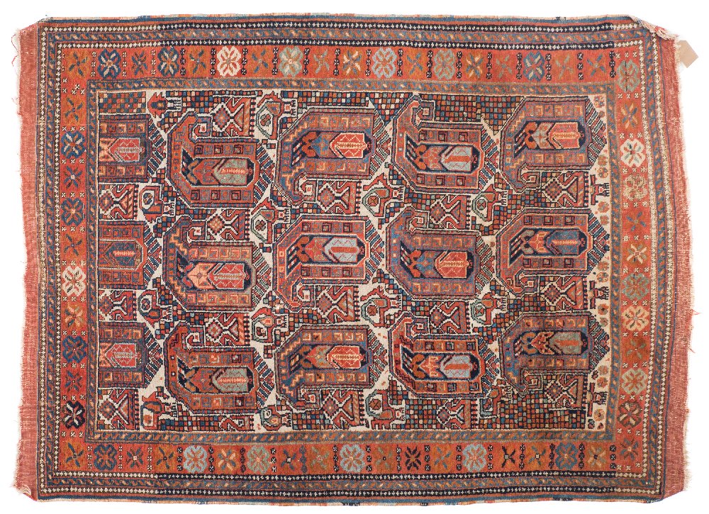 A Quashgai rug:, the beige field with large boteh indigo, pastel blue and rust medallions,