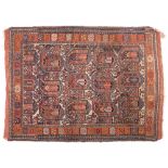 A Quashgai rug:, the beige field with large boteh indigo, pastel blue and rust medallions,