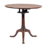 A mid 18th Century mahogany circular tea table:, the snap top on turned central column,