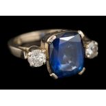 A sapphire and diamond three-stone ring: the central,