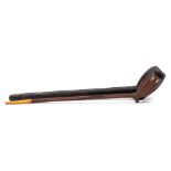 An unusual 19th century carved hardwood pipe: with elongated wood stem and amber mouthpiece,