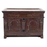 A 17th Century Continental oak coffer:, of small size, with a plain hinged moulded top,