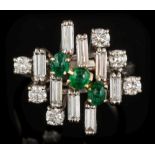 An emerald and diamond informal cluster ring: with three oval cabochon emeralds,
