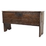 A 17th Century oak rectangular plank coffer:, with a plain hinged top,
