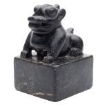 A large Chinese black hardstone seal: carved with a seated mythological beast and four-character