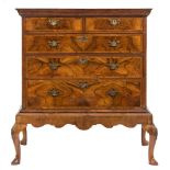 An early 18th Century walnut veneer and crossbanded chest on a later stand:,