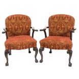A pair of carved mahogany open armchairs in the George II taste:,