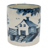 A Bovey Tracey blue and white pearlware small mug or can: painted with a vignette of a cottage,