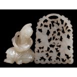 A Chinese jade boulder pendant and two small pendants: the first in the form of Shao Lao wearing