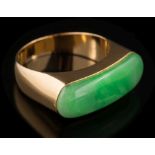 A jade mounted single-stone ring: the oblong polished jade approximately 24mm long x 7.