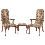 A pair of walnut open armchairs in the early 18th Century taste:, with upholstered stuff over backs,