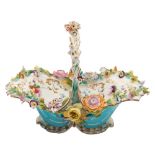 A Coalport porcelain flower basket: of typical rococo form with turquoise and gilt exterior,