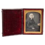 A cased daguerrotype of a seated woman:,