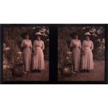 An early 20th century autochrome photograph stereoscope plate of two ladies in a garden:,