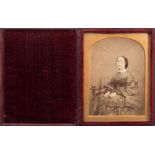 J C Barrable, London an ambrotype portrait of a seated woman:, hand tinted to face,