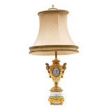 A late 19th century French 'Sevres' porcelain and ormolu table lamp: vase shaped body inset with