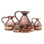 A large 19th century copper measuring jug: together with eight near matching graduated measuring